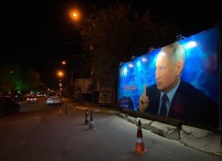 Terrorists affiliated with the Islamic regime of Iran post propaganda posters in support of Putin in Baghdad