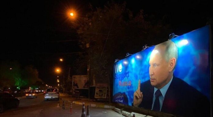 Terrorists affiliated with the Islamic regime of Iran post propaganda posters in support of Putin in Baghdad